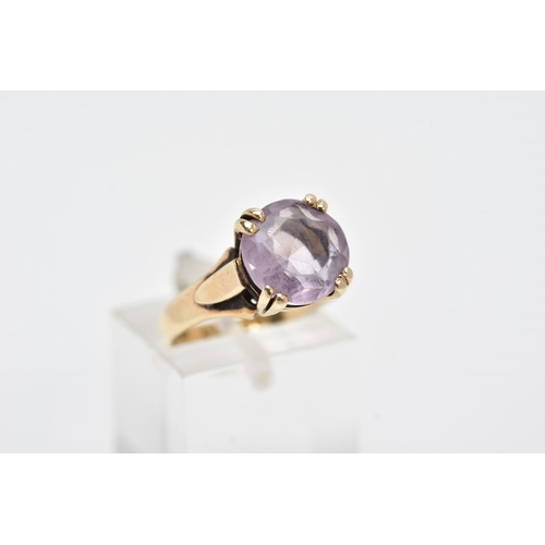 136 - A 9CT GOLD AMETHYST RING, designed with a double four claw set circular cut amethyst, textured shoul... 