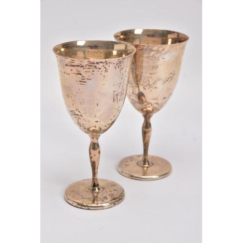 165 - TWO LATE 20TH CENTURY SILVER GOBLETS, each of a plain polished design gilt interior, tapered stem, o... 