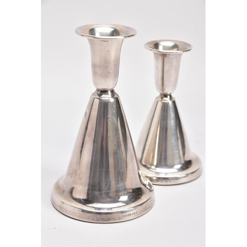 166 - TWO NORWEGIAN SILVER DOMED CANDLESTICKS, each of a plain polished design, on round weighted bases, t... 