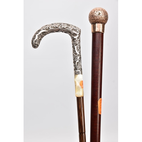 168 - TWO WALKING CANES, one set with a 9ct gold embossed foliate round handle with a vacant cartouche, ha... 