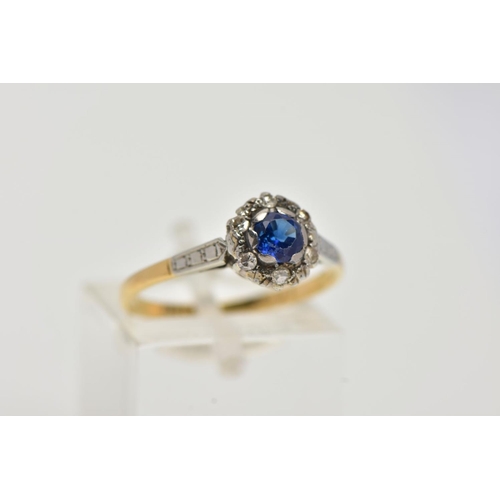 19 - A YELLOW METAL CLUSTER RING, designed with a central, circular cut blue sapphire within a surround o... 