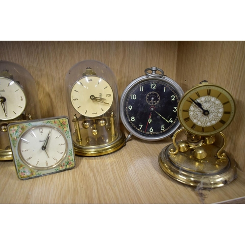 191 - NINETEEN MANTLE AND BEDSIDE CLOCKS, to include four plastic domed rotating pendulum clocks, such as ... 