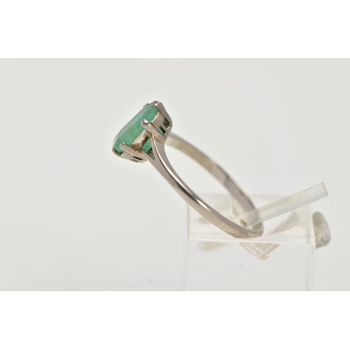 20 - A WHITE METAL EMERALD RING, centering on a claw set emerald, cut emerald approximate dimensions 8.2m... 