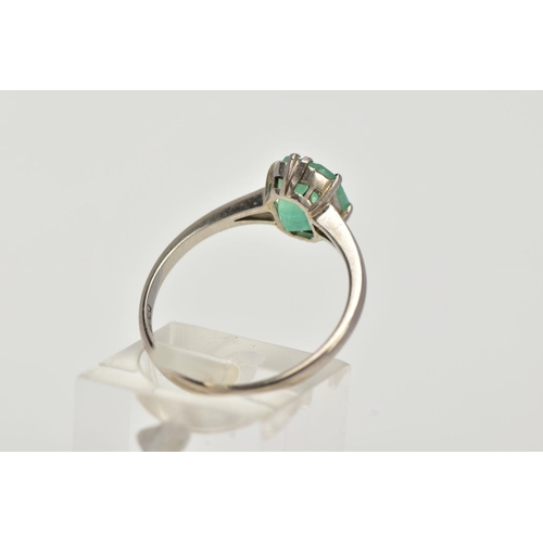 20 - A WHITE METAL EMERALD RING, centering on a claw set emerald, cut emerald approximate dimensions 8.2m... 