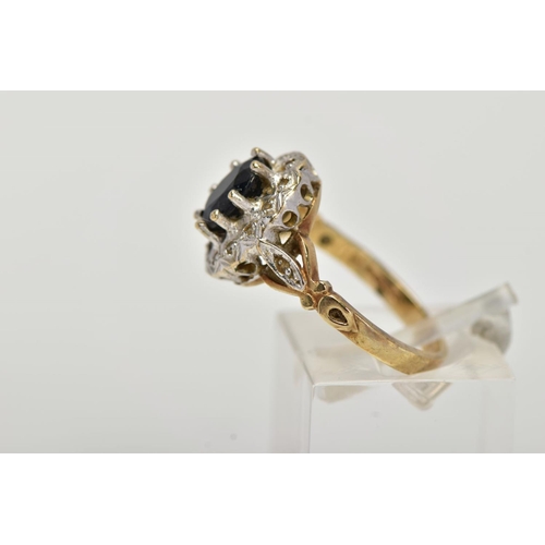 24 - A 9CT GOLD SAPPHIRE AND DIAMOND CLUSTER RING, raised cluster, centring on an oval cut blue sapphire,... 