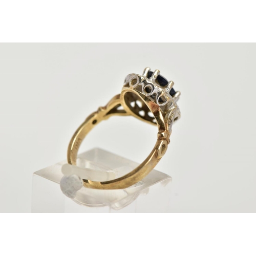 24 - A 9CT GOLD SAPPHIRE AND DIAMOND CLUSTER RING, raised cluster, centring on an oval cut blue sapphire,... 