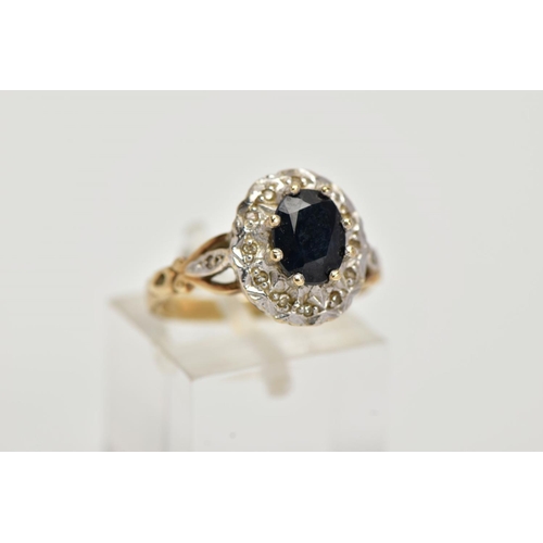 24 - A 9CT GOLD SAPPHIRE AND DIAMOND CLUSTER RING, raised cluster, centring on an oval cut blue sapphire,... 