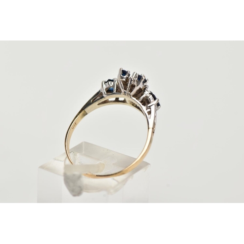 25 - A YELLOW METAL SAPPHIRE AND DIAMOND CLUSTER RING, set with a central claw set, circular cut blue sap... 