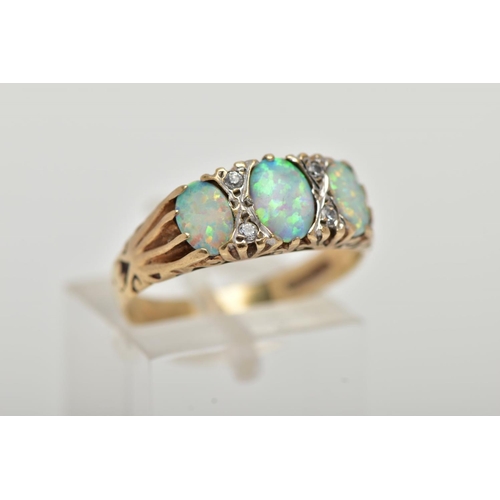 29 - A 9CT GOLD RING, designed with three synthetic oval cabochon opals, interspaced with circular cut co... 