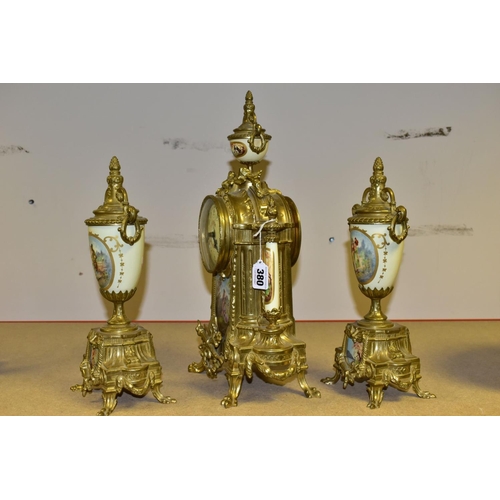 380 - A 20TH CENTURY BRASS AND PORCELAIN CLOCK GARNITURE, the porcelain panels transfer printed with coupl... 