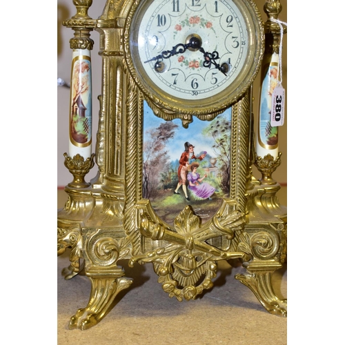 380 - A 20TH CENTURY BRASS AND PORCELAIN CLOCK GARNITURE, the porcelain panels transfer printed with coupl... 