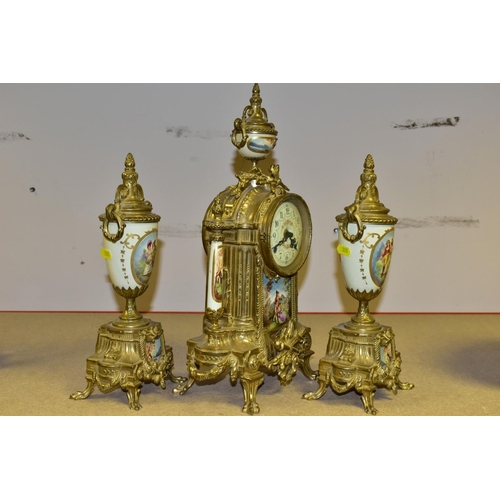 380 - A 20TH CENTURY BRASS AND PORCELAIN CLOCK GARNITURE, the porcelain panels transfer printed with coupl... 