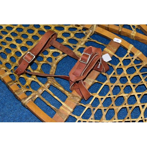 414 - A PAIR OF LATE 20TH CENTURY BENTWOOD AND GUT STRUNG SNOWSHOES, with tan leather straps, length 121cm