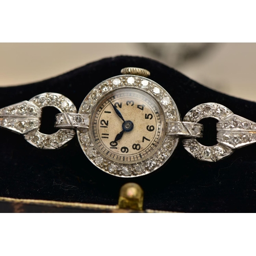 44 - A LADIES PLATINUM DIAMOND SET COCKTAIL WRISTWATCH, round discoloured dial, Arabic numerals, blue han... 