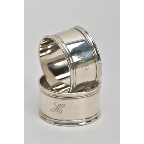 45 - TWO SILVER NAPKIN RINGS, plain polished design reeded rims, one engraved with an initial 'M' the oth... 