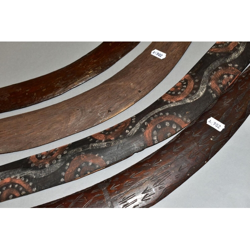 451 - FOUR TRIBAL ART AUSTRALIAN ABORIGINAL BOOMERANGS, to include one carved to the side of arrows, cross... 