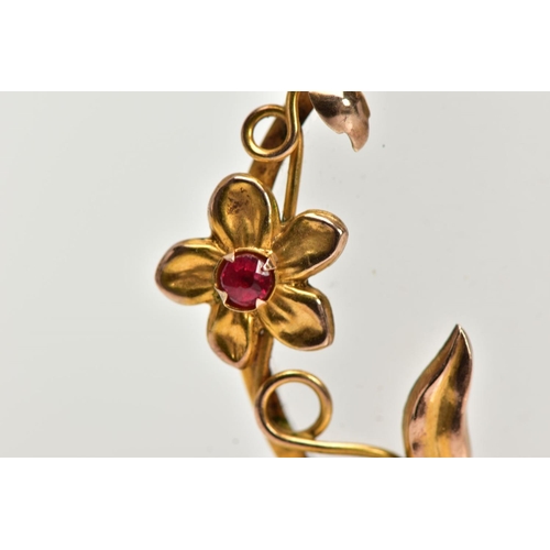 48 - A 9CT GOLD RUBY SET PENDANT, double sided glass pendant of a circular form, decorated with a floral ... 