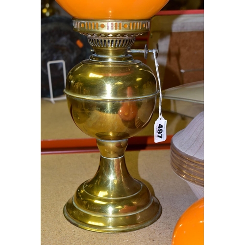 497 - A BRASS OIL LAMP, in working condition with chimney and damaged orange shade, together with a squat ... 