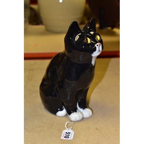 510 - A WINSTANLEY POTTERY CAT, black and white colourway with yellow eyes, signed to the base, height app... 