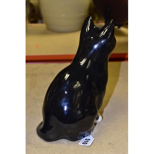 510 - A WINSTANLEY POTTERY CAT, black and white colourway with yellow eyes, signed to the base, height app... 