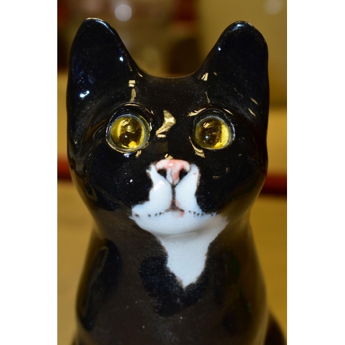 510 - A WINSTANLEY POTTERY CAT, black and white colourway with yellow eyes, signed to the base, height app... 