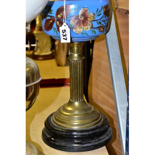 537 - FOUR BRASS BASED TWIN BURNER OIL LAMPS, one with a blue glass hand painted reservoir, the column mou... 