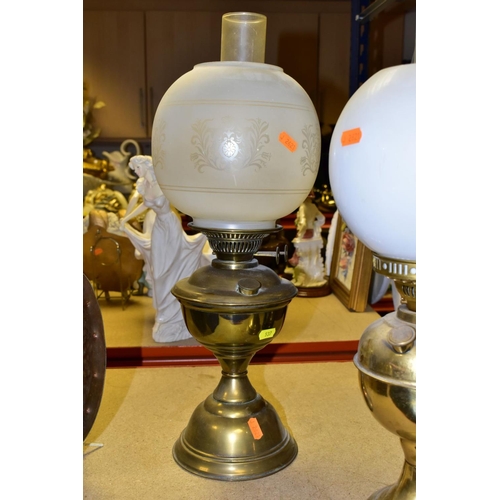 537 - FOUR BRASS BASED TWIN BURNER OIL LAMPS, one with a blue glass hand painted reservoir, the column mou... 