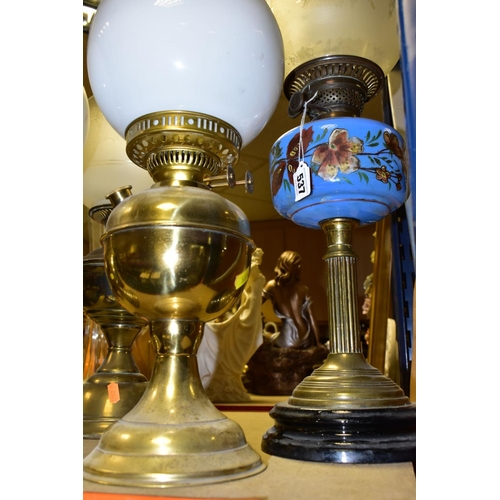 537 - FOUR BRASS BASED TWIN BURNER OIL LAMPS, one with a blue glass hand painted reservoir, the column mou... 