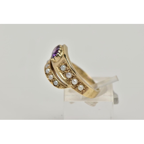 6 - A YELLOW METAL AMETHYST AND SEED PEARL RING, of a cross over design, set with a single oval cut amet... 