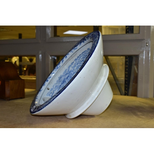 636 - A LATE VICTORIAN BLUE AND WHITE TRANSFER PRINTED POTTERY OVAL TOILET BOWL, the interior with figures... 