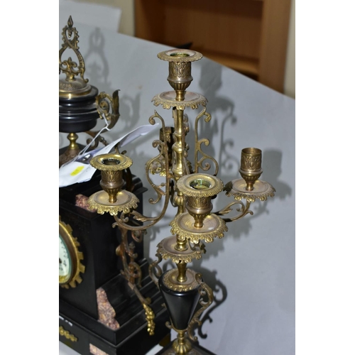 692 - A LATE 19TH CENTURY BLACK SLATE, MARBLE AND GILT METAL CLOCK GARNITURE, the clock with urn shaped su... 