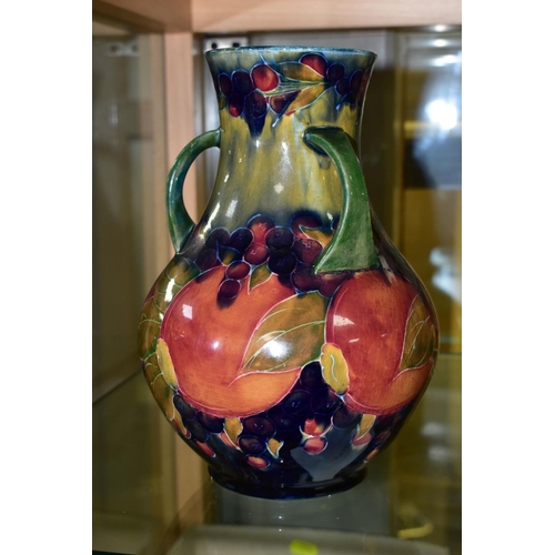 771 - A MOORCROFT POTTERY THREE HANDLED VASE, Pomegranate pattern, signed and dated 1918, height 22cm (Con... 