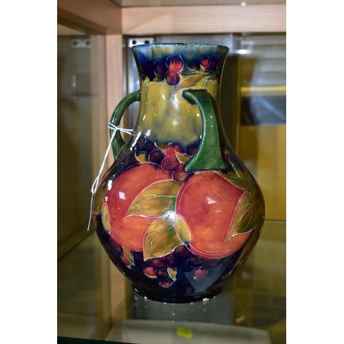 771 - A MOORCROFT POTTERY THREE HANDLED VASE, Pomegranate pattern, signed and dated 1918, height 22cm (Con... 