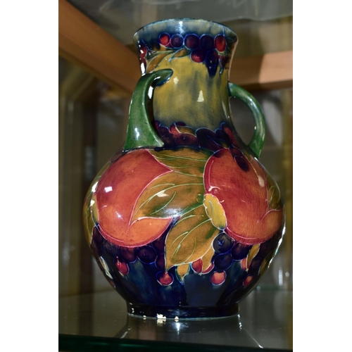 771 - A MOORCROFT POTTERY THREE HANDLED VASE, Pomegranate pattern, signed and dated 1918, height 22cm (Con... 