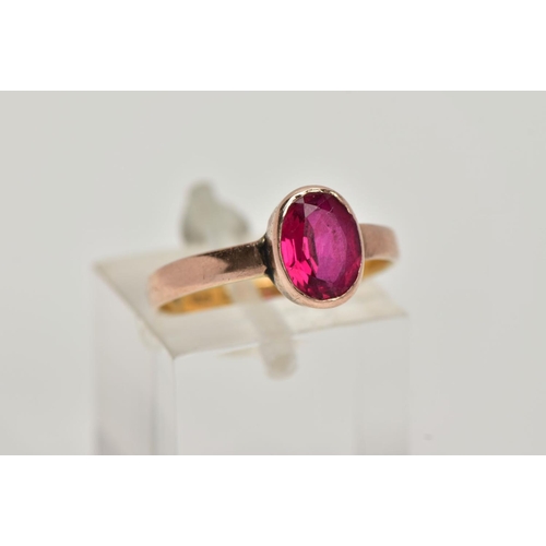 8 - A VICTORIAN YELLOW METAL RING, collet mounted oval cut synthetic ruby,  plain polished band, rubbed ... 