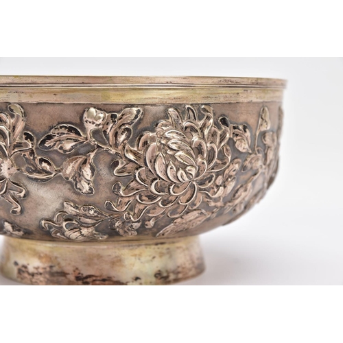 84 - A LATE 19TH/EARLY 20TH CENTURY SHANGHAI SILVER BOWL, embossed floral design on a slightly raised cir... 