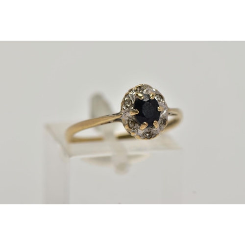 9 - A 9CT GOLD SAPPHIRE AND DIAMOND CLUSTER RING, raised cluster, centring on a claw set, oval cut blue ... 