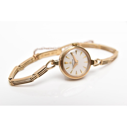 90 - A LADIES 1950'S 9CT GOLD OMEGA WRISTWATCH, the circular face with tapered baton hour markers and gat... 