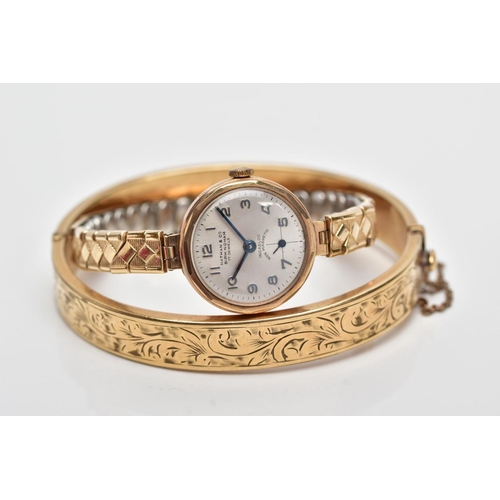 93 - A HINGED BANGLE AND A WRISTWATCH, the hinged bangle with engraved scrolling acanthus leaf decoration... 