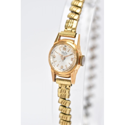 99 - A WRISTWATCH, the Mu Du wristwatch with 18ct gold head and gold plated expandable strap, with 18ct i... 