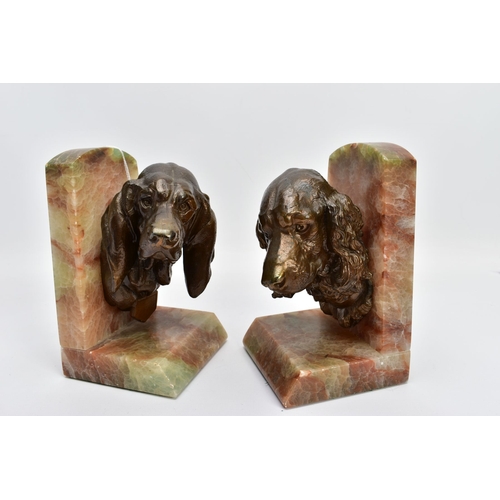 60A - A PAIR OF EARLY 20TH CENTURY FRENCH ALABASTER BOOKENDS mounted with a bronzed springer spaniel on on... 