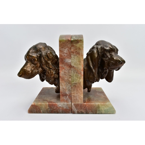 60A - A PAIR OF EARLY 20TH CENTURY FRENCH ALABASTER BOOKENDS mounted with a bronzed springer spaniel on on... 