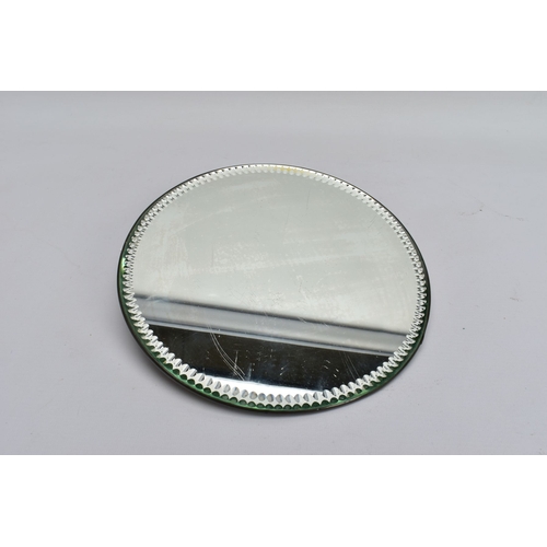 75A - A 1920'S CIRCULAR MIRROR TABLE TOP STAND, with notched edge, with hanging hooks verso, diameter 25cm