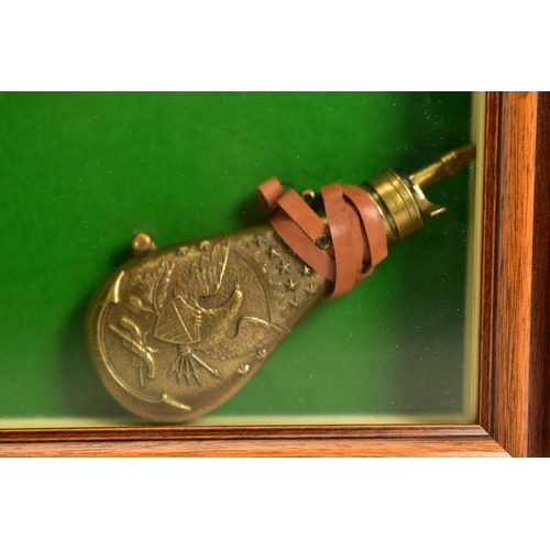 129 - A NEATLY FRAMED DISPLAY CASE containing a cast metal replica of a Collette Gravity pistol, together ... 