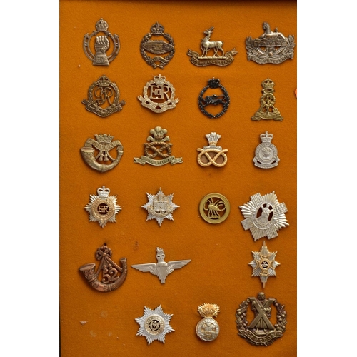 88 - A LARGE FRAME OF OVER THIRTY FIVE MISCELLANEOUS MILITARY CAP BADGES including North Staffs, RAC, RAF... 