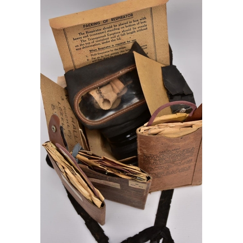 89 - A BOX CONTAINING TWO WWII ERA HOME FRONT GAS MASKS in boxes and three sets of anti gas eye shields, ... 