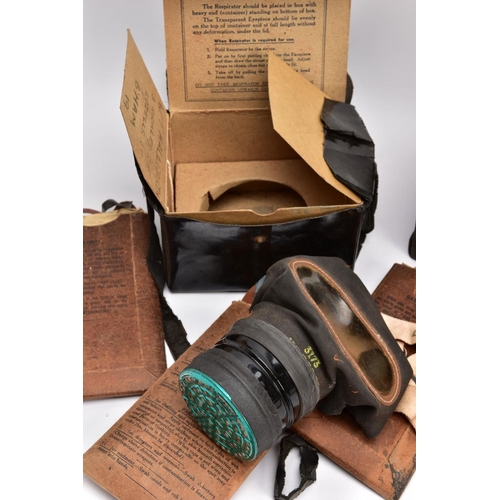 89 - A BOX CONTAINING TWO WWII ERA HOME FRONT GAS MASKS in boxes and three sets of anti gas eye shields, ... 