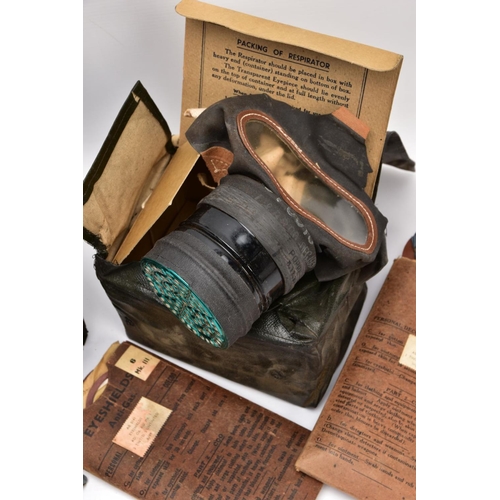 89 - A BOX CONTAINING TWO WWII ERA HOME FRONT GAS MASKS in boxes and three sets of anti gas eye shields, ... 