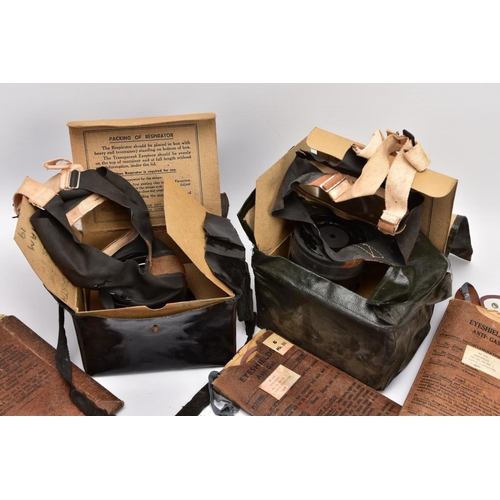 89 - A BOX CONTAINING TWO WWII ERA HOME FRONT GAS MASKS in boxes and three sets of anti gas eye shields, ... 