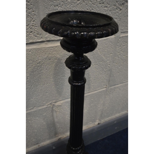 1386 - A BLACK PAINTED CAST IRON CANDLE STAND, height 70cm